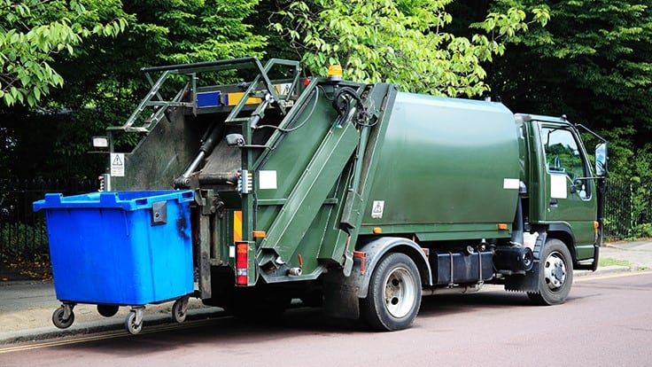 truck dumping commerical waste container