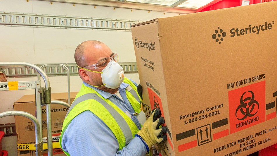 Stericycle driver holding biohazard box