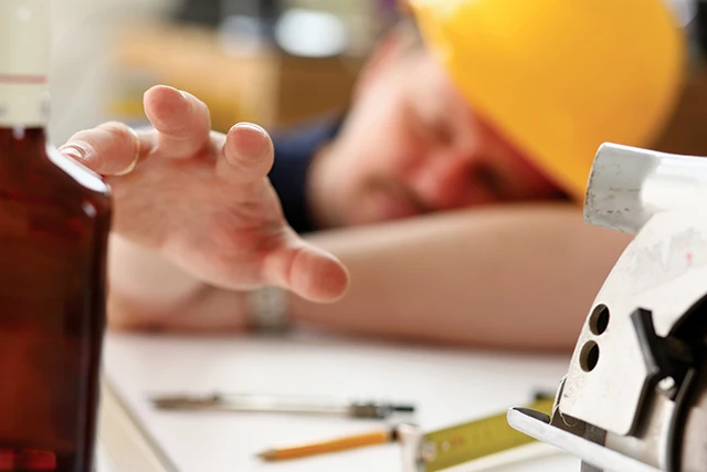 photo of a construction worker falling asleep on the job