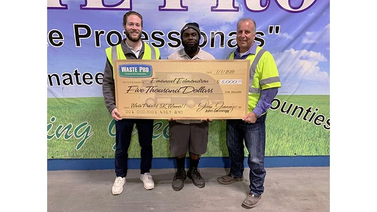 Emanuel Edmondson receives his check from Waste Pro President Sean Jennings, left, and Southwest Florida Regional Vice President Keith Banasiak, right.