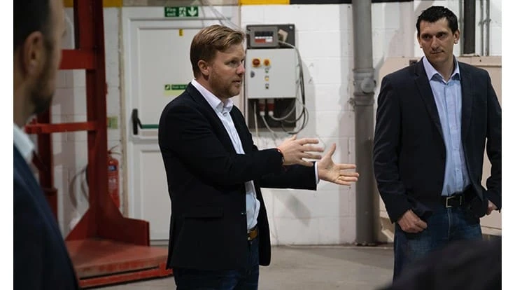 Toby McCartney, center, of MacRebur says the company’s process can consume more than 1 million discarded plastic bags in one mile of pavement.