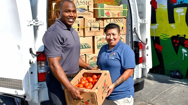 Brian Hunter, operations manager at Athens Services, helps deliver fresh food to the St. Francis Center 