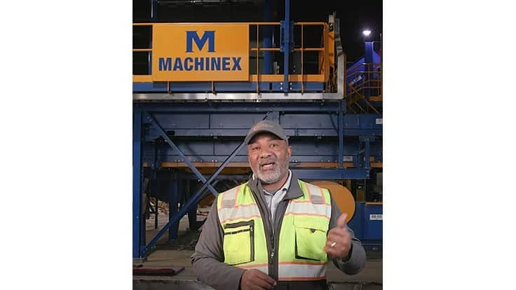 Man talking in front of Machinex system