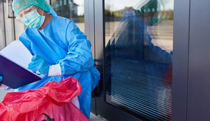 Medical worker bagging waste