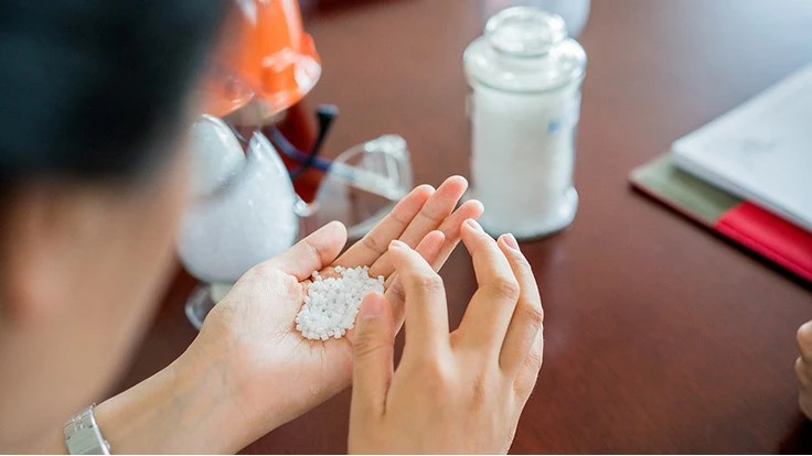 hand holding total styrene plastic