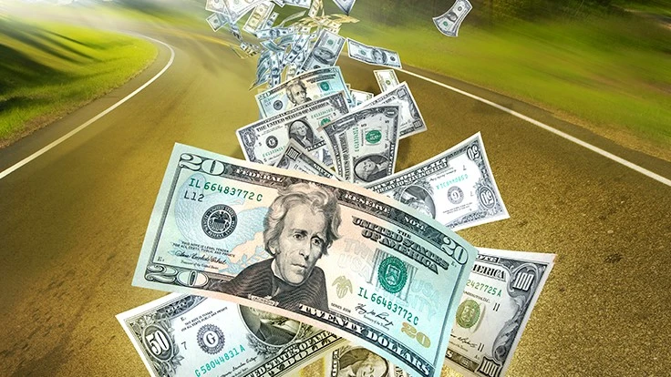 trail of 20 dollar bills down a swerving road