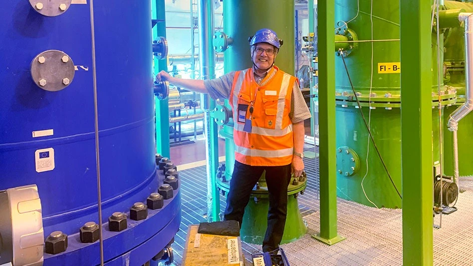 a man in safety gear standing before machinery
