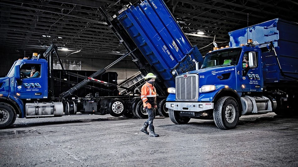 DTG Recycle dump trucks in garage