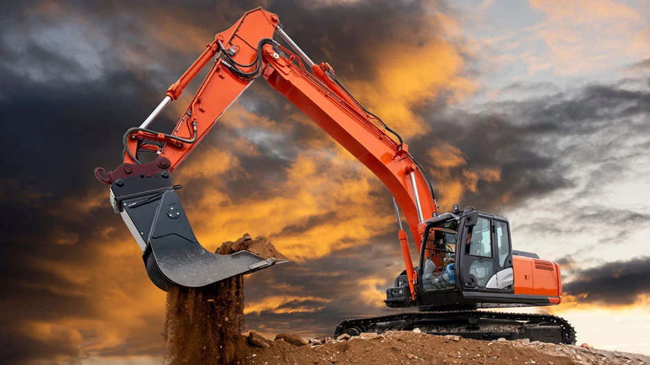 excavator against a sunset