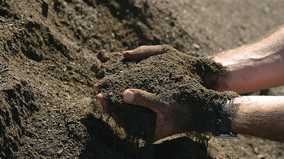 hands scooping compost