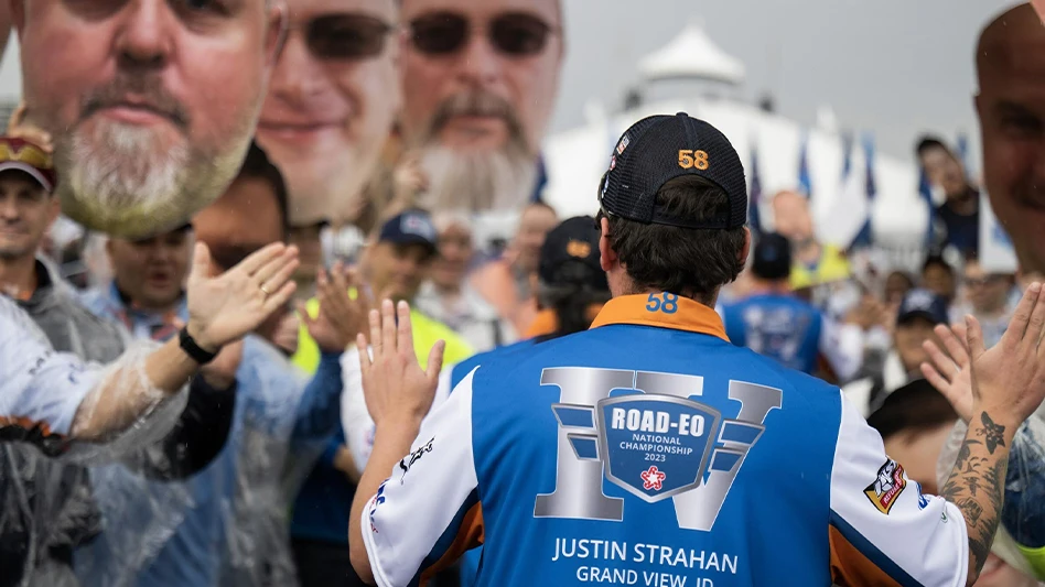 A Republic Services employee high-fives spectators as he competes in the company's ROAD-EO National Championship event in Phoenix.