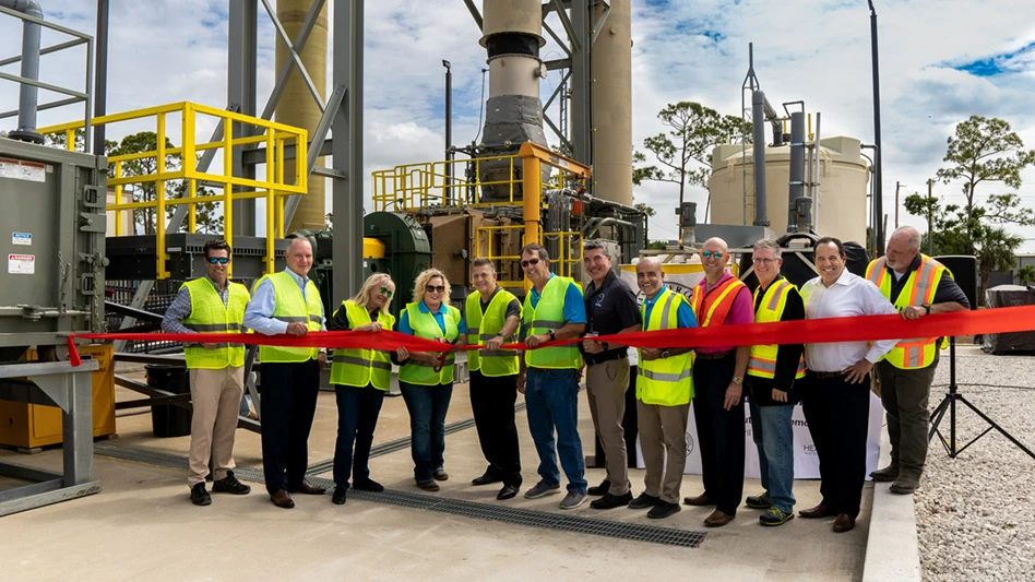 Twelve people celebrate the ribbon cutting at Indian River County's leachate conentrator.