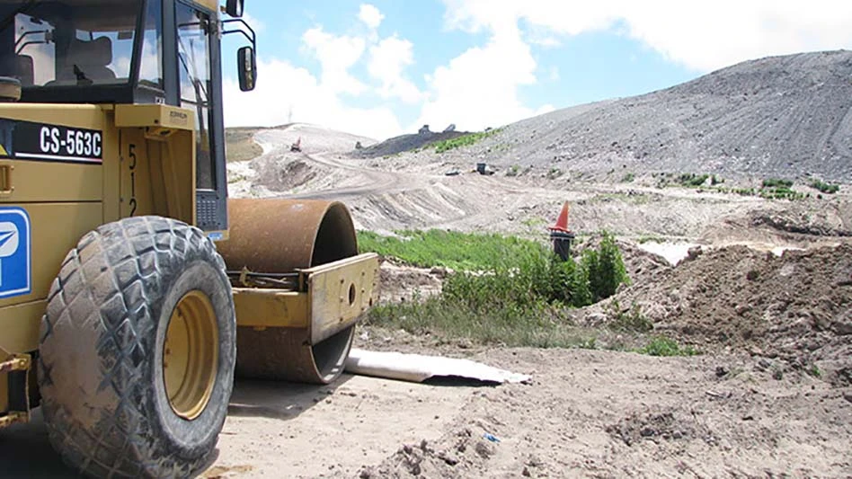 landfill equipment parked in front of landfill