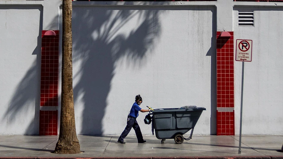 maintenance worker pushing refuse been