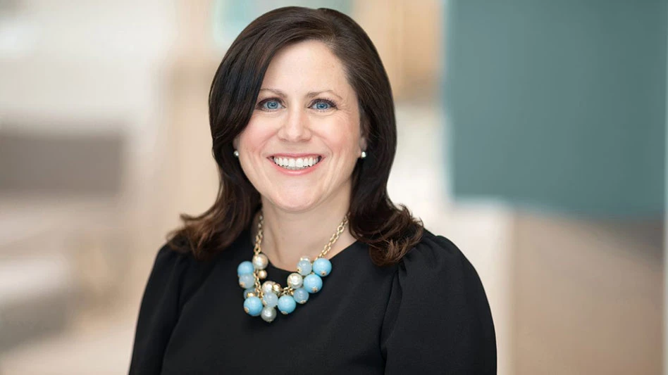 a smiling brown haired woman