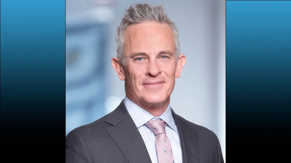 man with grey hair wearing white shirt, grey suit jacket and pink tie