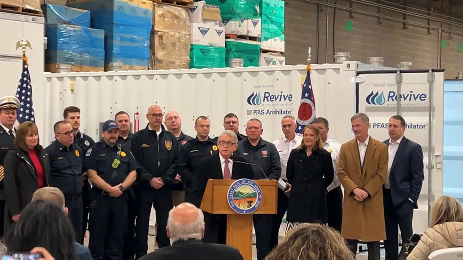 Ohio Governor Mike DeWine standing in front of a row of men