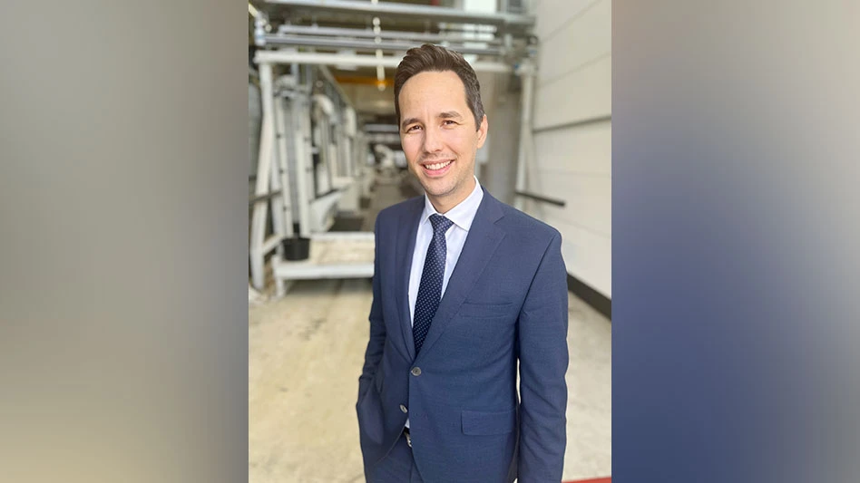 photo of white man in blue suit smiling