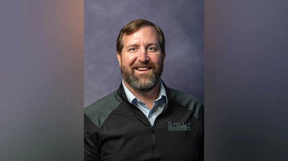 a smiling bearded white man in a stellar three-quarter zip