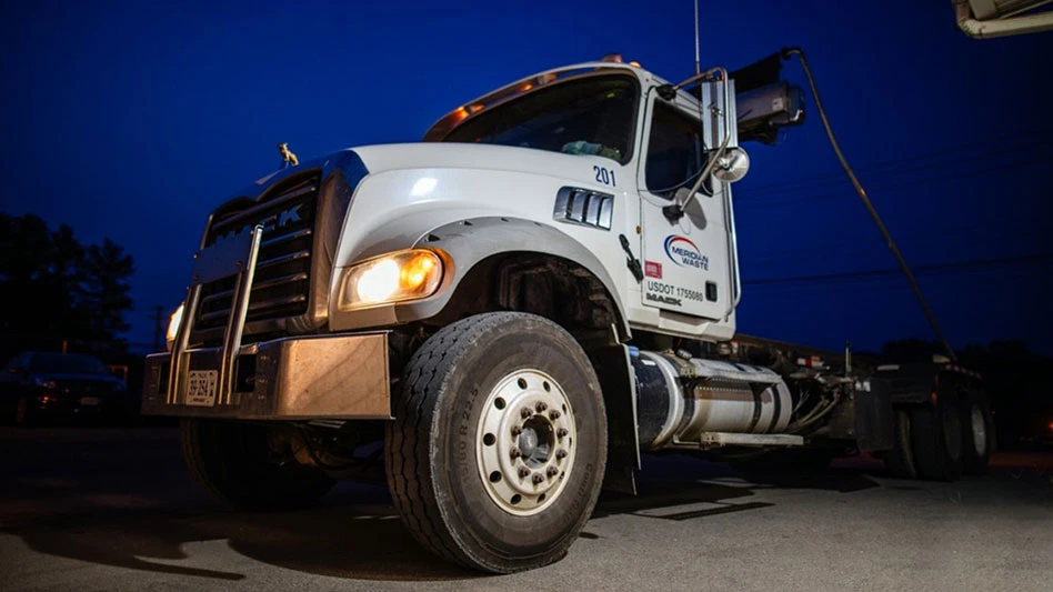 Meridian Waste roll-off truck pre-dawn