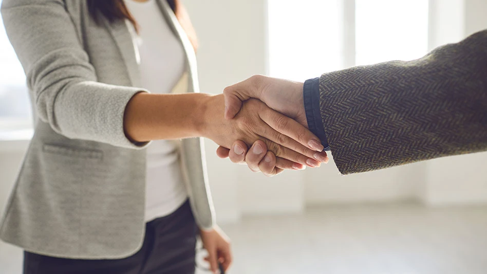 Handshake of businesspeople. Female and male hand makes a handshake in the office.