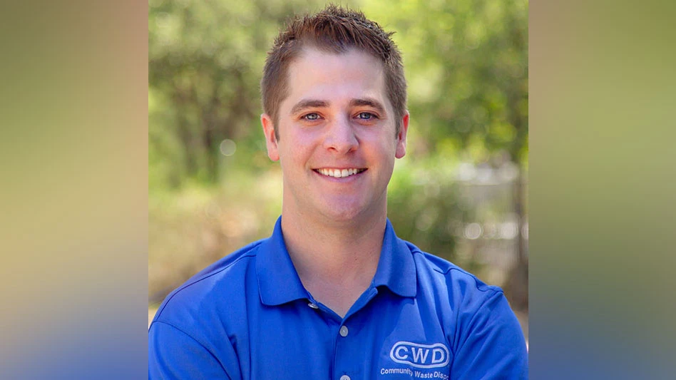 a smiling brown haired man in a blue CWD shirt