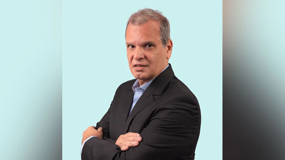 image of a man in a suit with gray hair and arms crossed