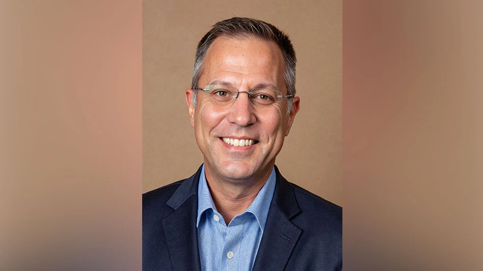 Photo of a man with glasses, smiling