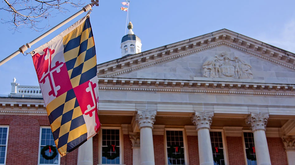 maryland flag with the general assembly building in the background