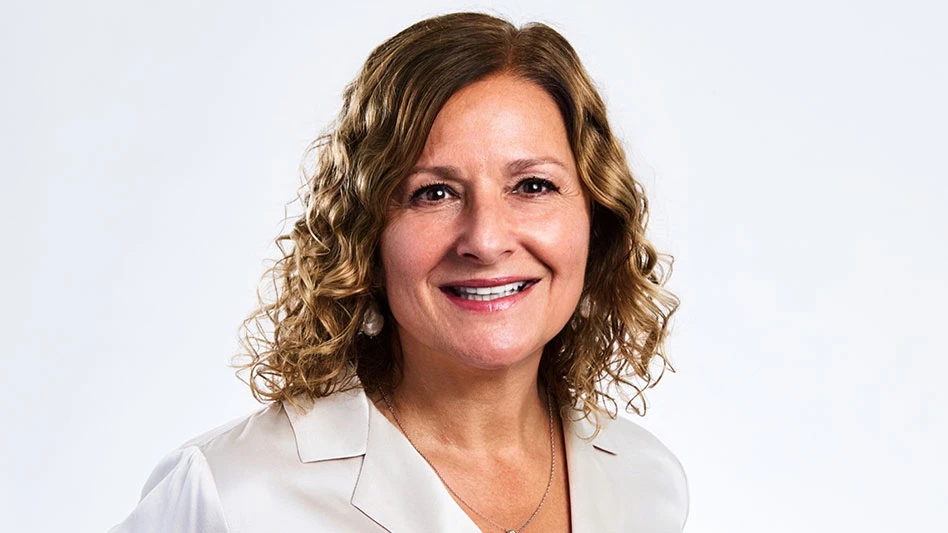 photo of a white woman with brown curly hair smiling