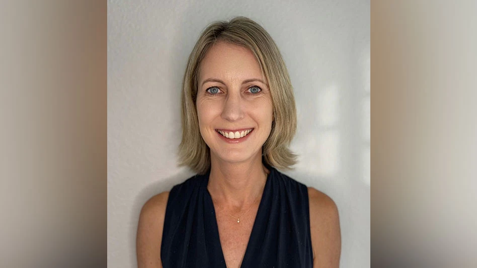 a smiling blonde woman wearing a v-neck sleeveless black shirt