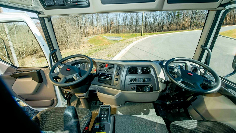 driver and passenger seat and dashboard of truck with steering wheel on both sides