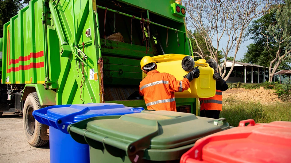 Garbage truck picking up trash