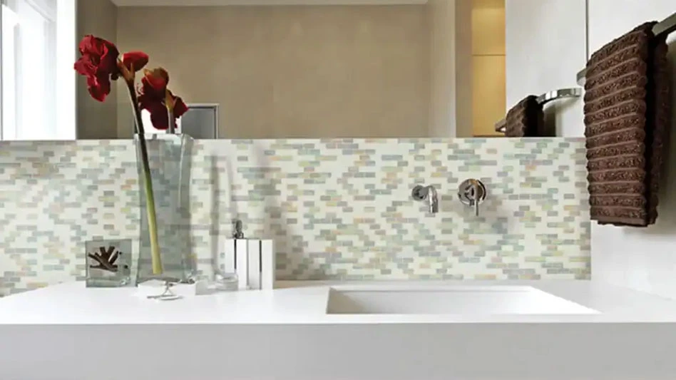 a glass tile backsplash in a bathroom